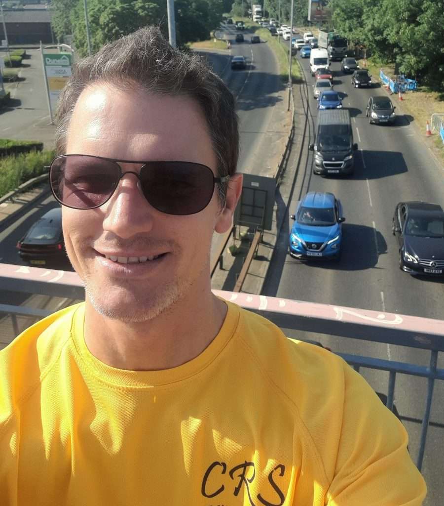 Craig Smith of CRS Editorial on a bridge with traffic in the background.